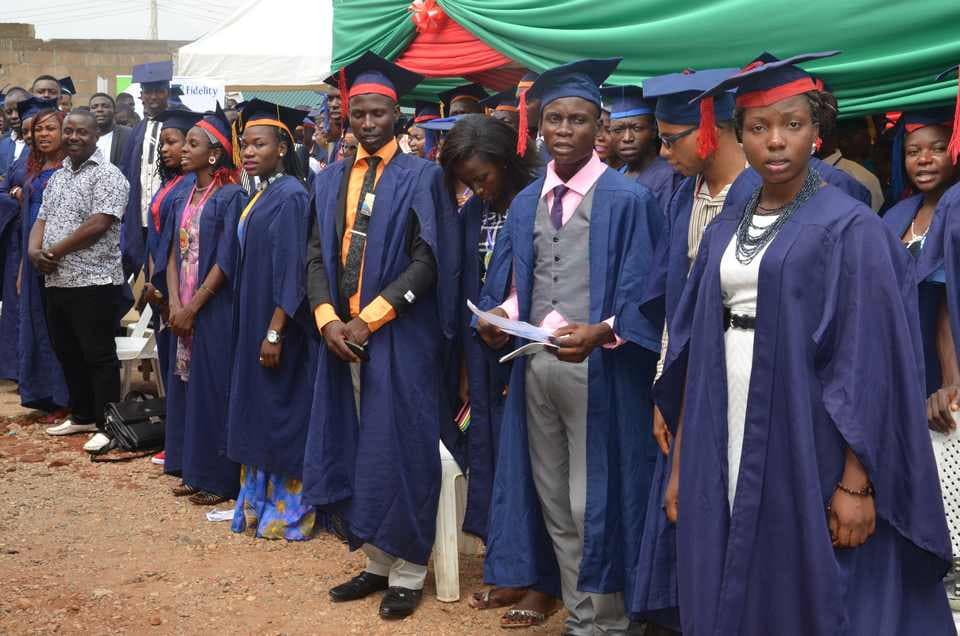 Newly admitted students in academic caps and gowns lined up at a MOAUM matriculation ceremony