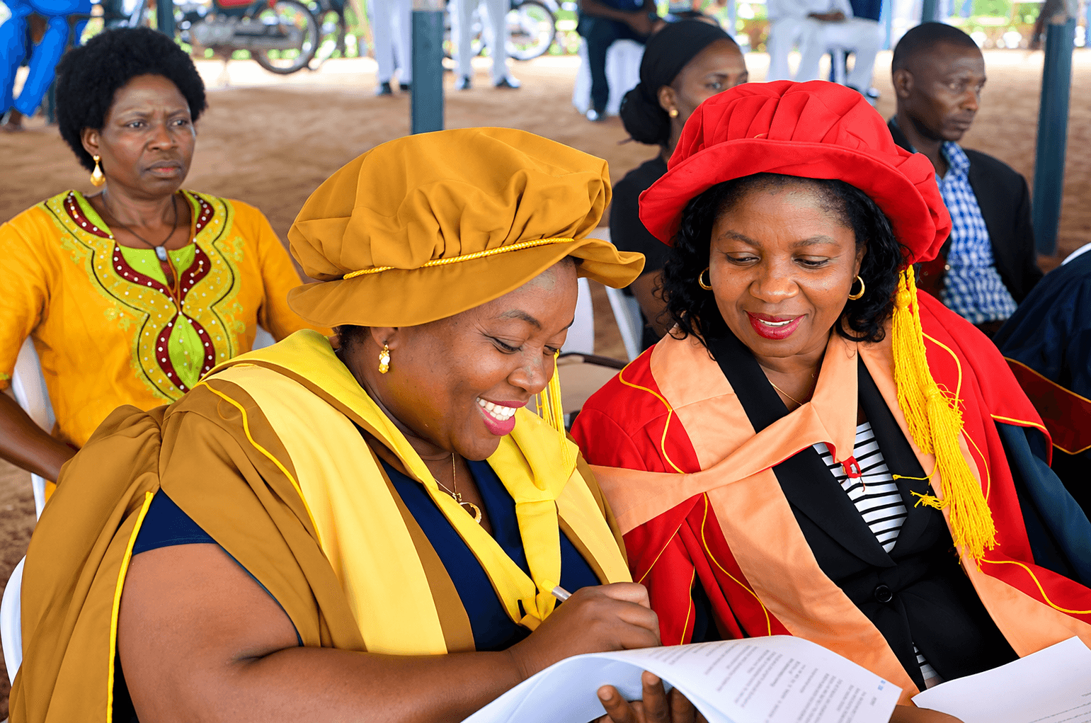Academics in ceremonial regalia at a university event.